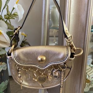 Juicy Couture Gold Mini Leather Charmed Bag.